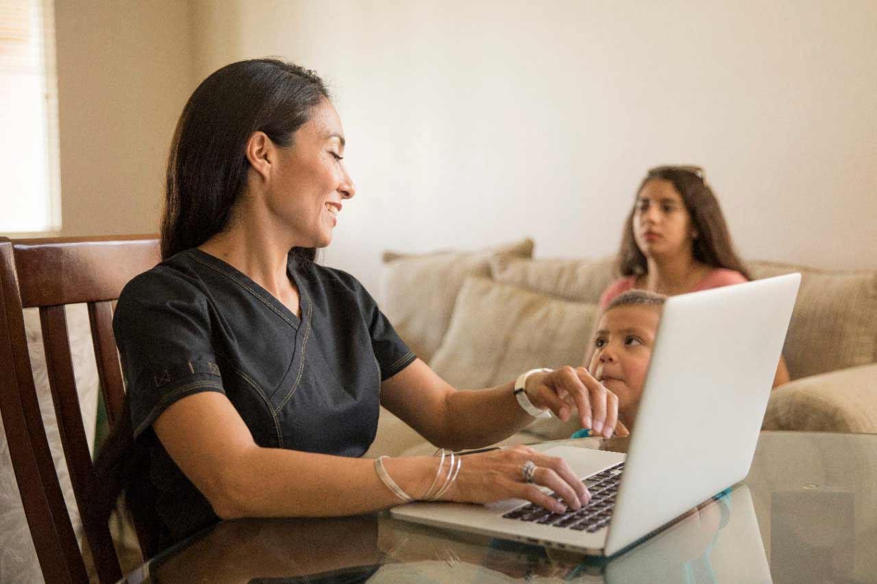 Student working from home with children